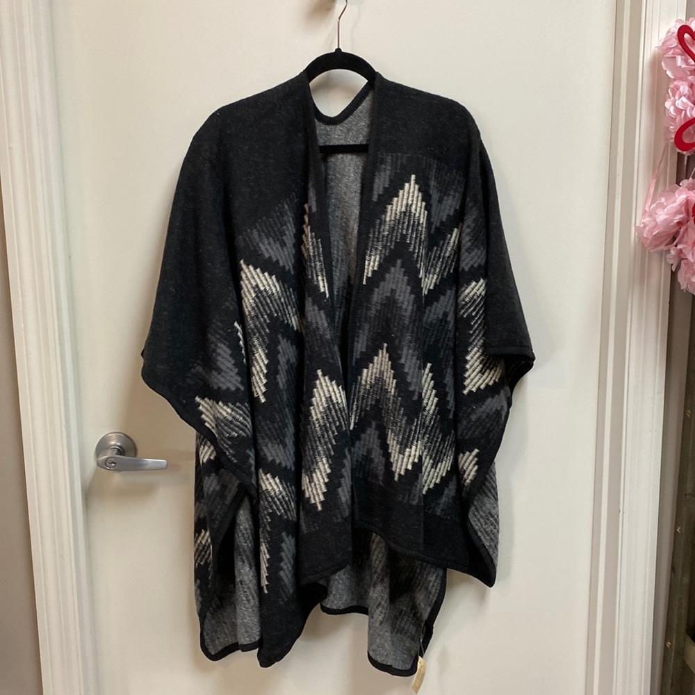 Pull on cape like jacket. Multi color gray, black and cream.